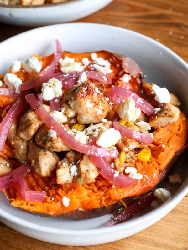 Sweet, spicy, and healthy! Hot honey chicken and toasted corn stuffed in roasted sweet potatoes with feta and arugula.
