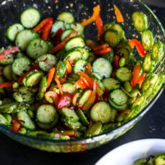 Fresh & crunchy! This Chopped Ginger Cucumber Salad features edamame, bell peppers, and a zesty sweet Thai dressing.