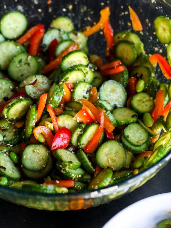 Fresh & crunchy! This Chopped Ginger Cucumber Salad features edamame, bell peppers, and a zesty sweet Thai dressing.
