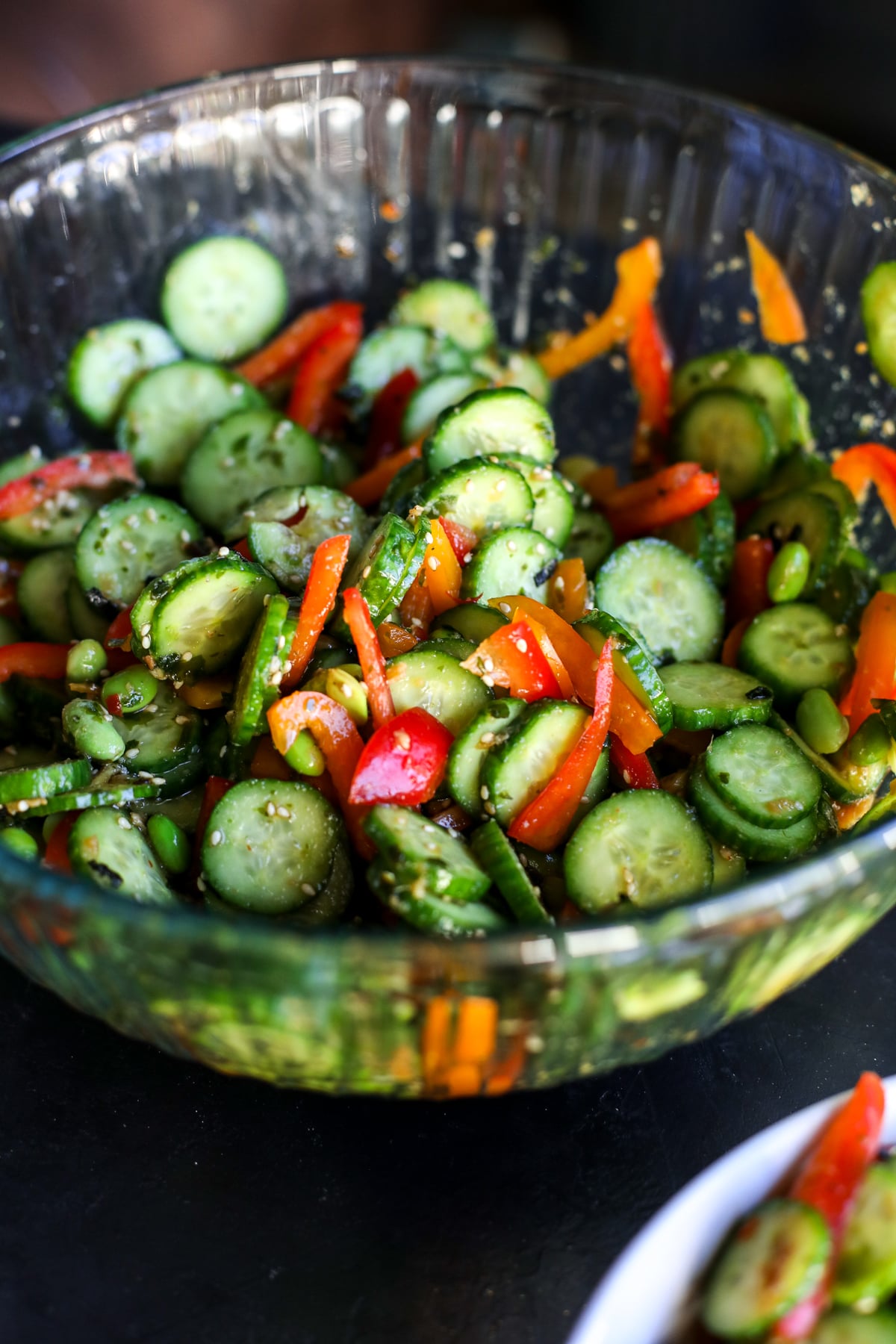 Fresh & crunchy! This Chopped Ginger Cucumber Salad features edamame, bell peppers, and a zesty sweet Thai dressing.