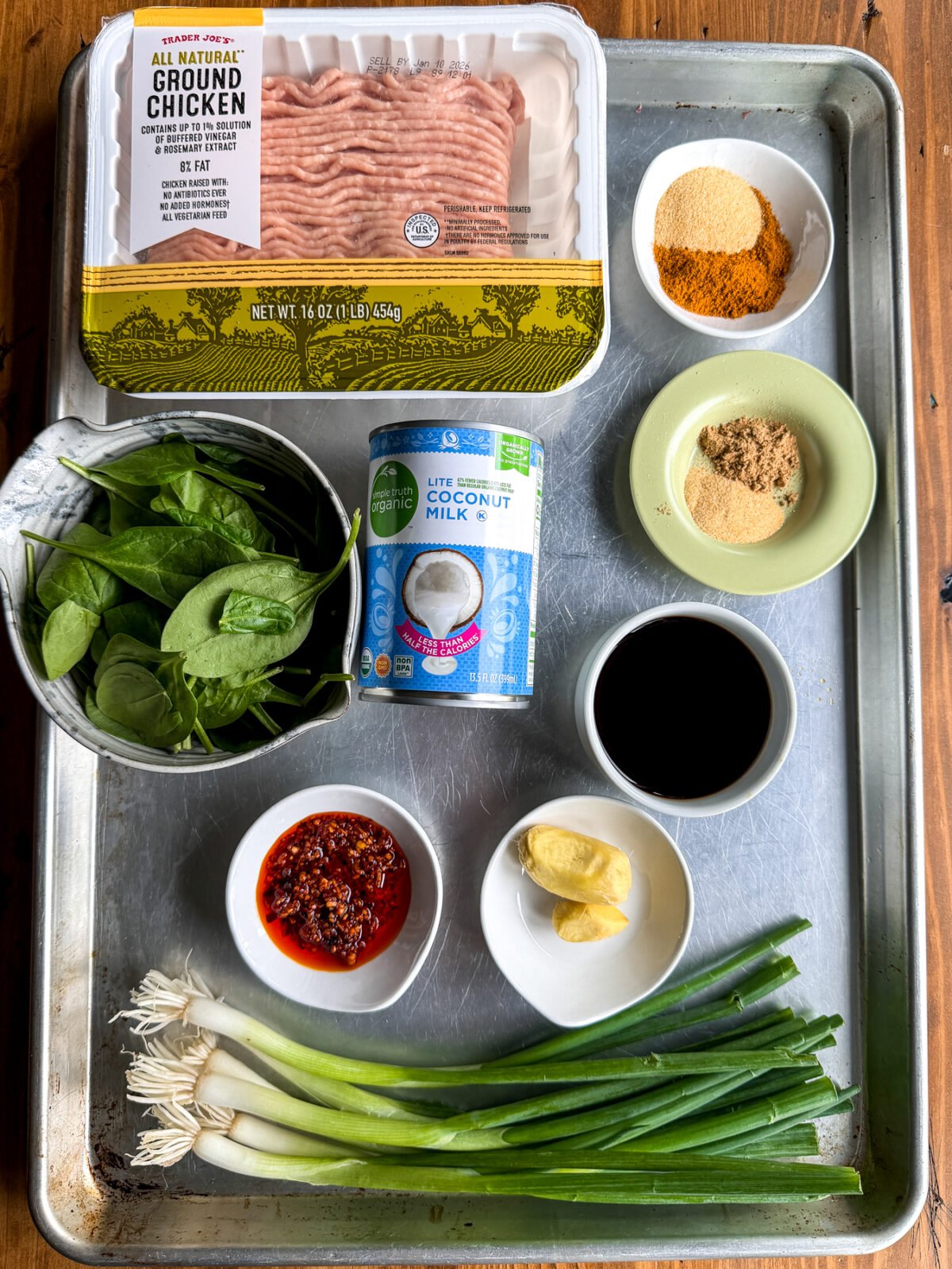 Easy one-pan dinner! Juicy chicken dumpling meatballs baked in a creamy, spinach-packed coconut curry sauce.