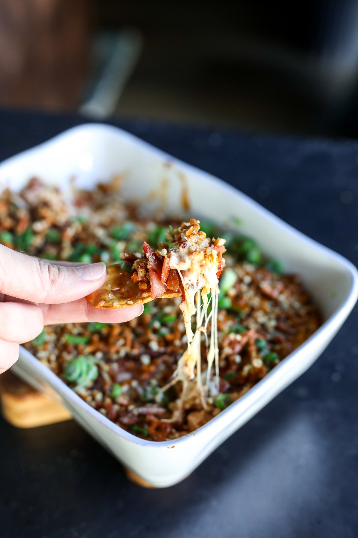 The ultimate party dip! Creamy hot honey chicken and bacon topped with a buttery, crunchy pretzel crust. Bake until gooey.