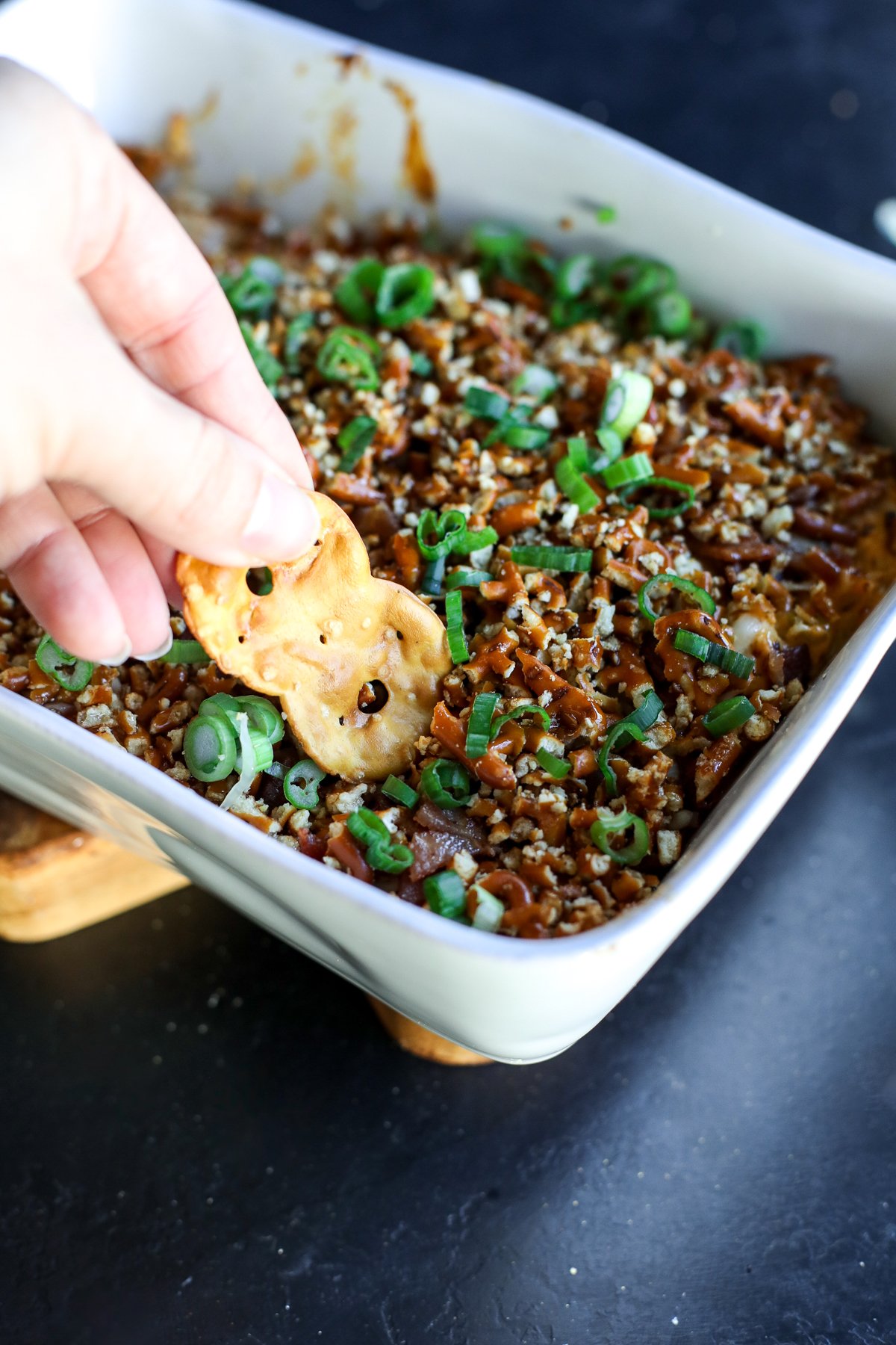 The ultimate party dip! Creamy hot honey chicken and bacon topped with a buttery, crunchy pretzel crust. Bake until gooey.