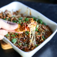 The ultimate party dip! Creamy hot honey chicken and bacon topped with a buttery, crunchy pretzel crust. Bake until gooey.