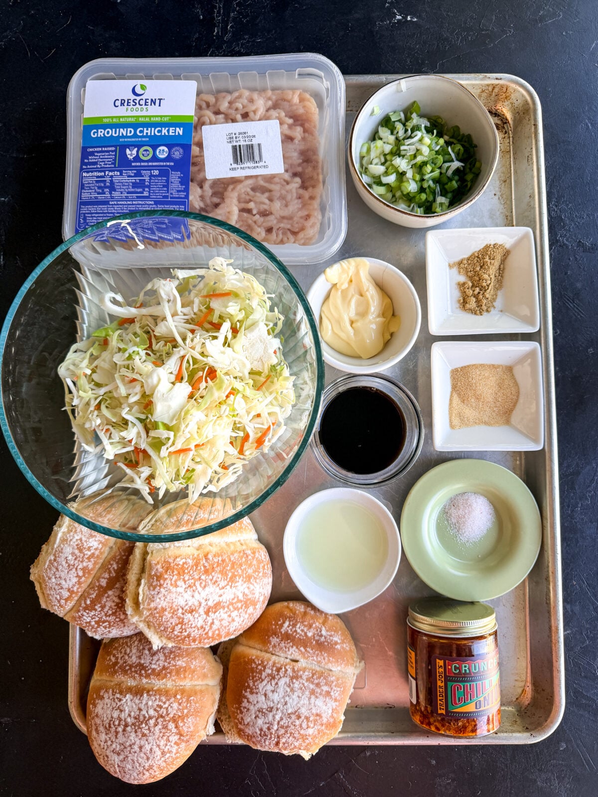 The ultimate fusion burger! Ginger-garlic chicken patties with a zesty Kewpie slaw and a kick of spicy chili crunch.