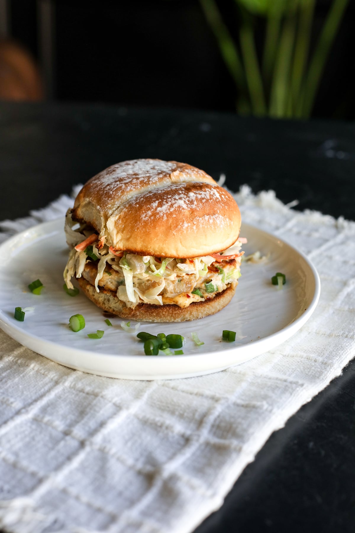 The ultimate fusion burger! Ginger-garlic chicken patties with a zesty Kewpie slaw and a kick of spicy chili crunch.