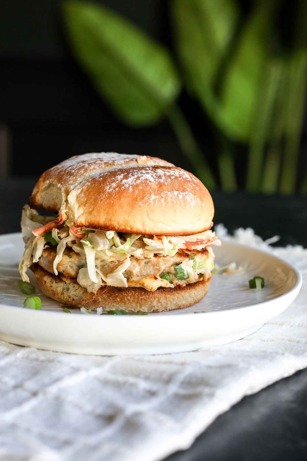 The ultimate fusion burger! Ginger-garlic chicken patties with a zesty Kewpie slaw and a kick of spicy chili crunch.