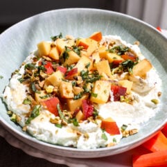 Creamy whipped feta topped with fresh peaches, pistachios, and hot honey makes an easy, crowd-pleasing summer appetizer.