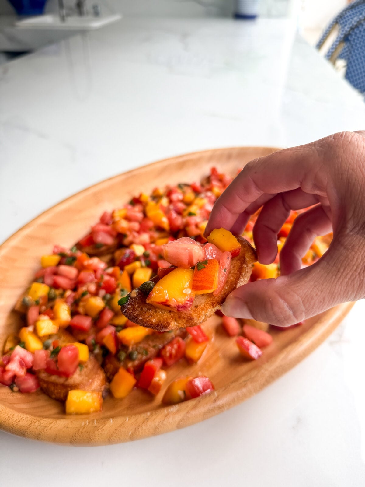Fresh peach tomato bruschetta with basil and a tangy vinaigrette. An easy make-ahead appetizer for summer gatherings.