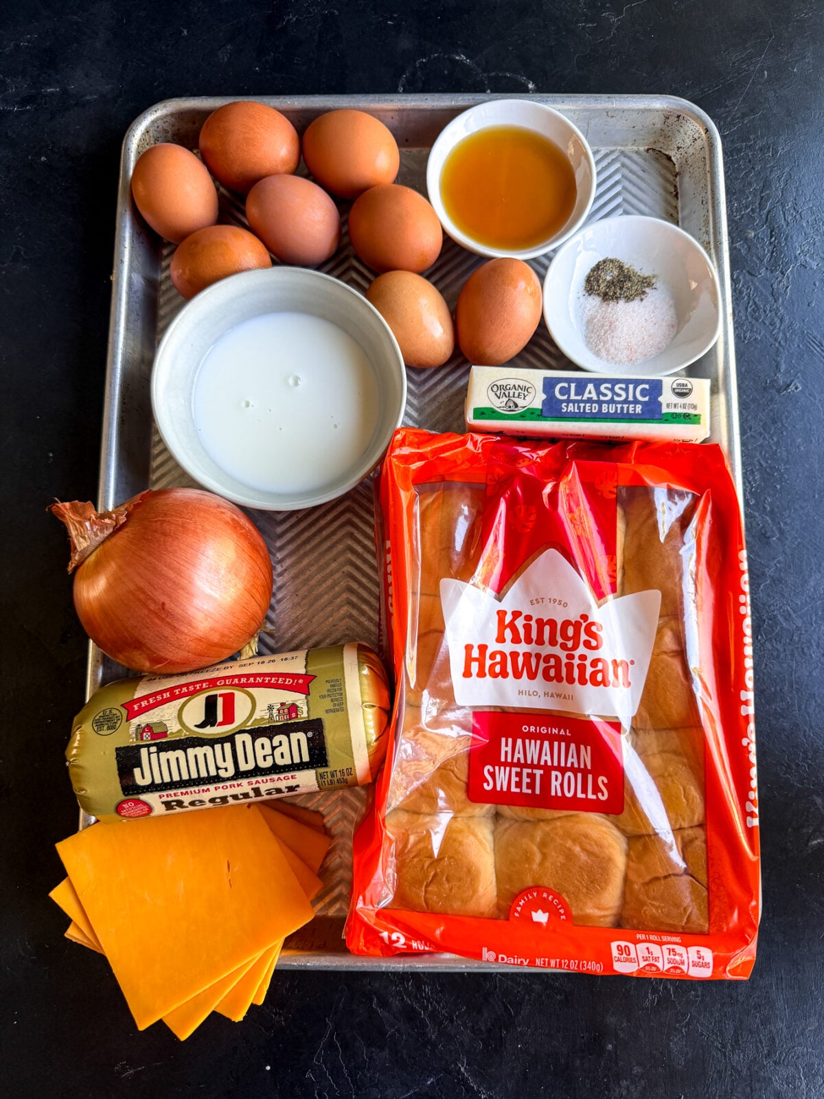 Easy sausage breakfast sliders made with eggs, cheddar cheese, and maple butter on Hawaiian rolls. A crowd-pleasing brunch recipe.