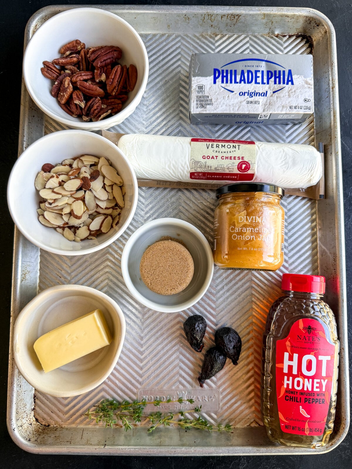 Creamy whipped goat cheese topped with caramelized onion jam, candied pecans, almonds, figs and hot honey. An easy, impressive holiday appetizer!