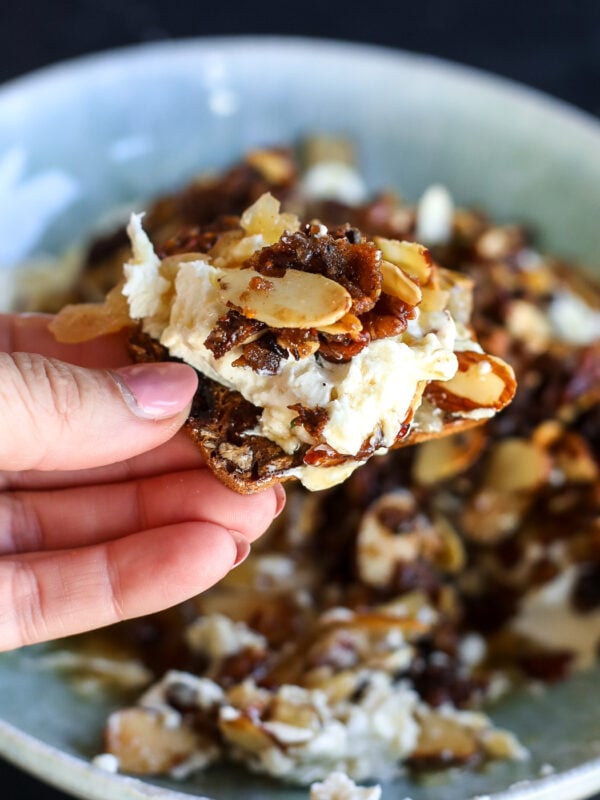 Creamy whipped goat cheese topped with caramelized onion jam, candied pecans, almonds, figs and hot honey. An easy, impressive holiday appetizer!