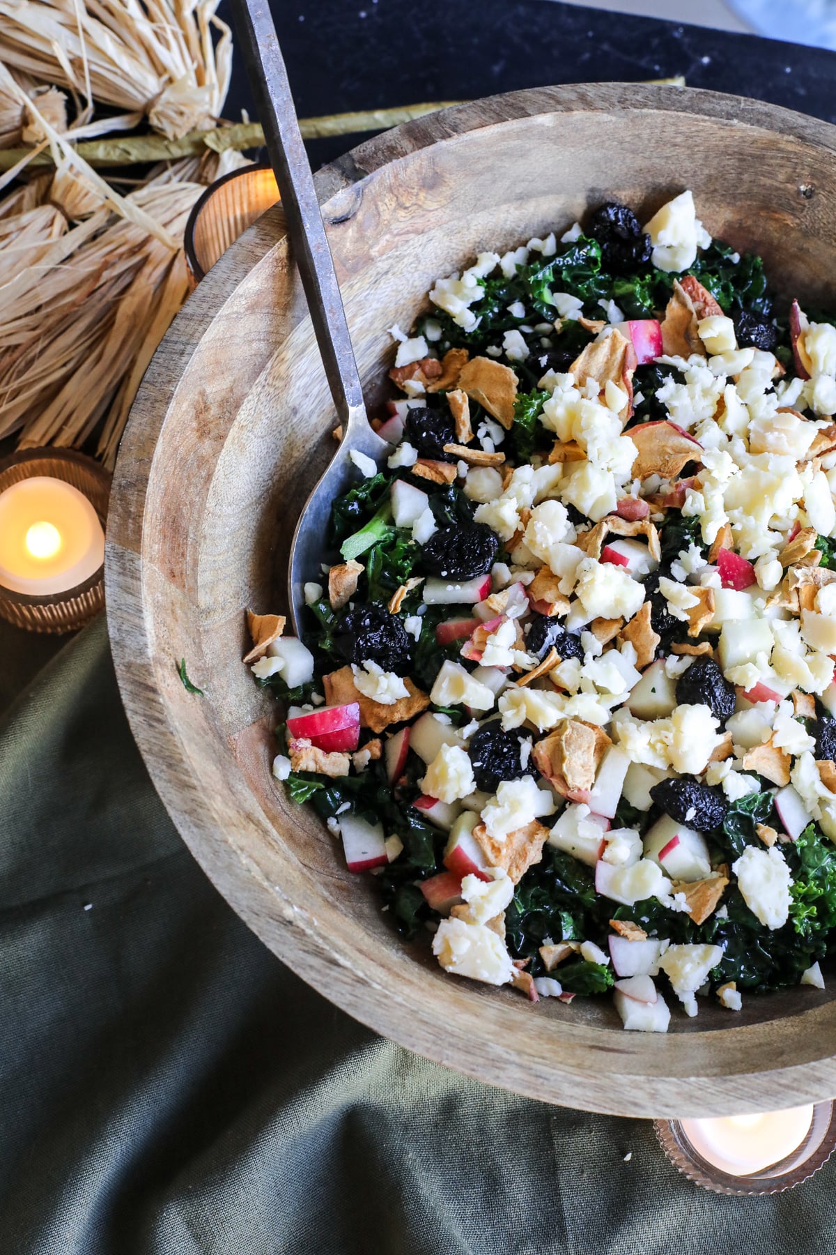This Apple Kale Salad is loaded with crisp apples, sharp cheddar, pecans, dried cherries and apple chips, tossed in a homemade rosemary apple vinaigrette.