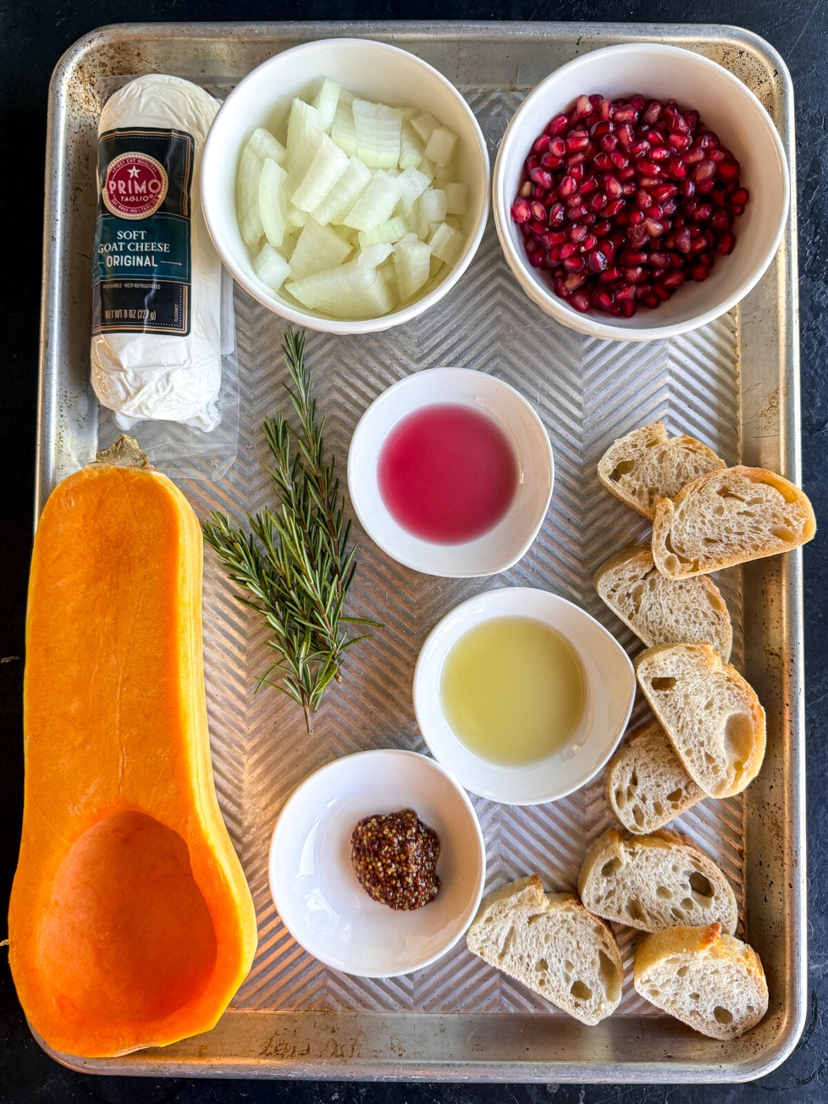 This Butternut Squash & Pomegranate Bruschetta is an easy holiday appetizer with creamy goat cheese, roasted squash and a tangy mustard dressing.