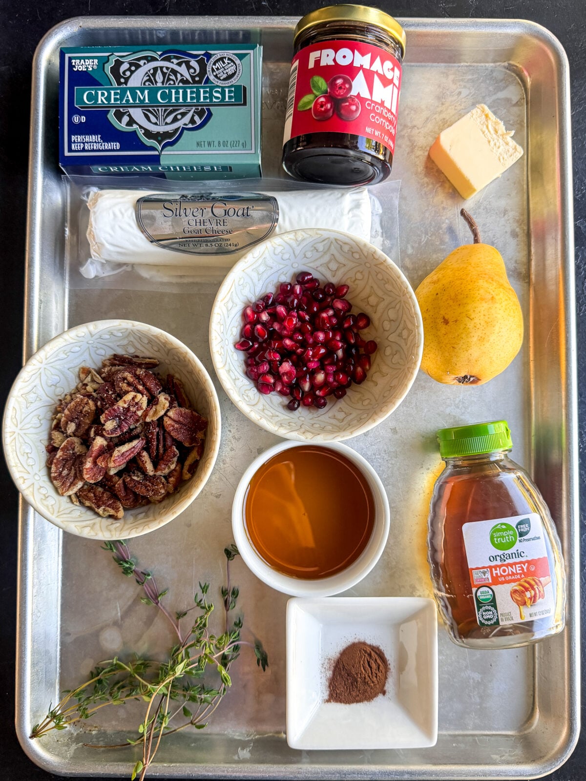 This Cranberry Pear Whipped Goat Cheese is the perfect holiday appetizer with creamy goat cheese, cranberry chutney, maple pecans, fresh pears and pomegranate!