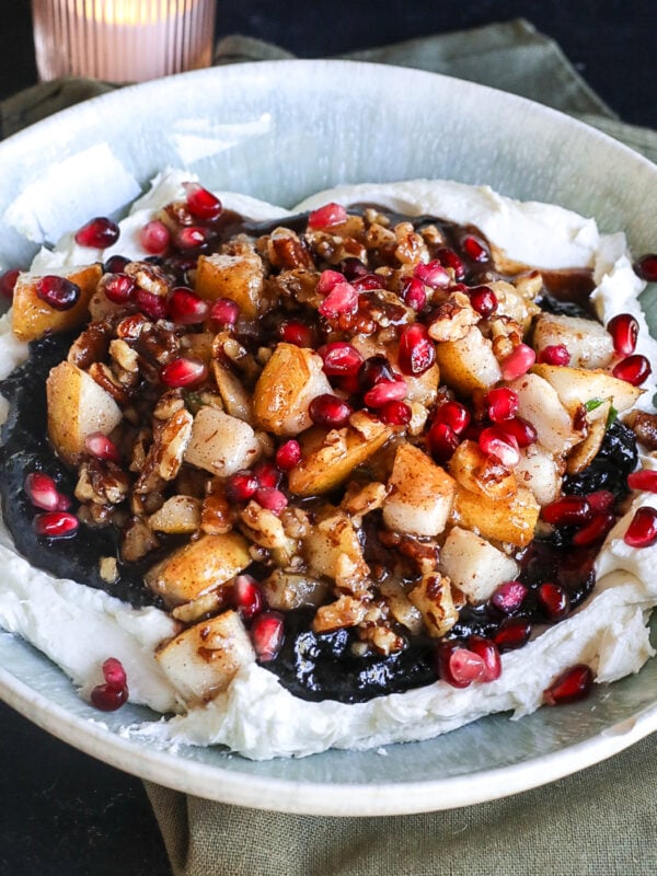 This Cranberry Pear Whipped Goat Cheese is the perfect holiday appetizer with creamy goat cheese, cranberry chutney, maple pecans, fresh pears and pomegranate!